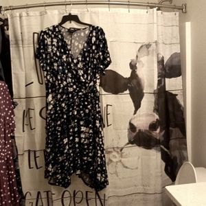 Plus Size 1X Faux Wrap Loop Knot detail at left waist. Hem curves down slightly.